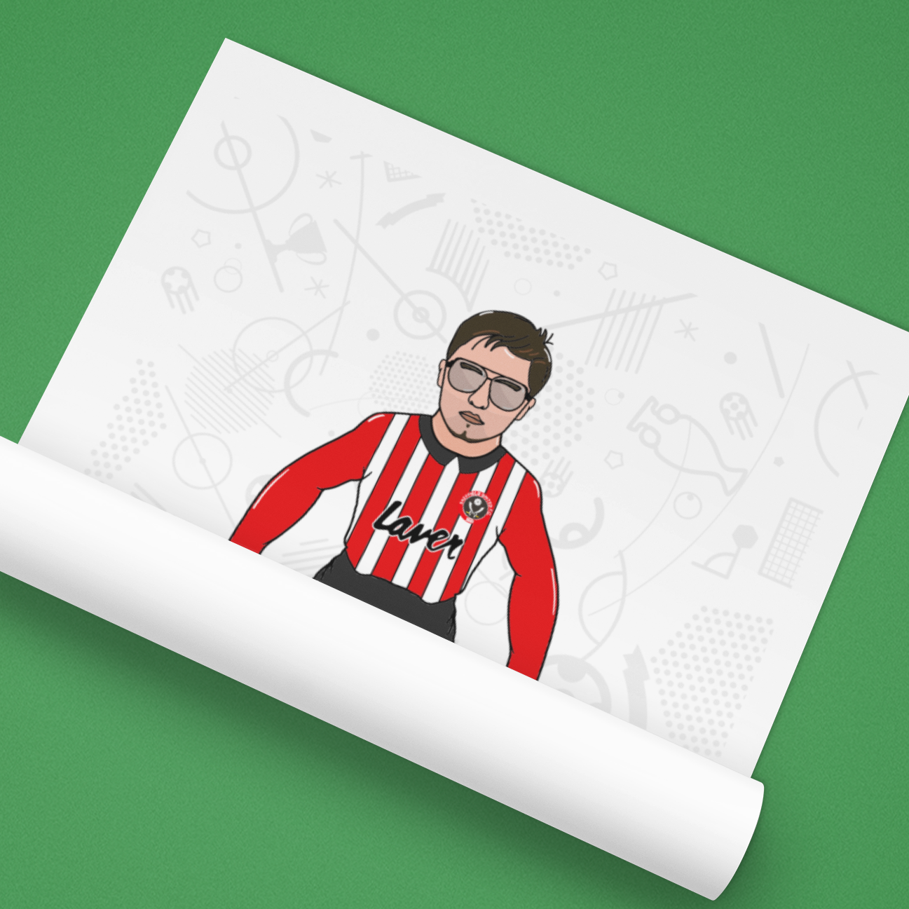 Roll of paper with a printed design of a person wearing a red and black striped shirt on a green background